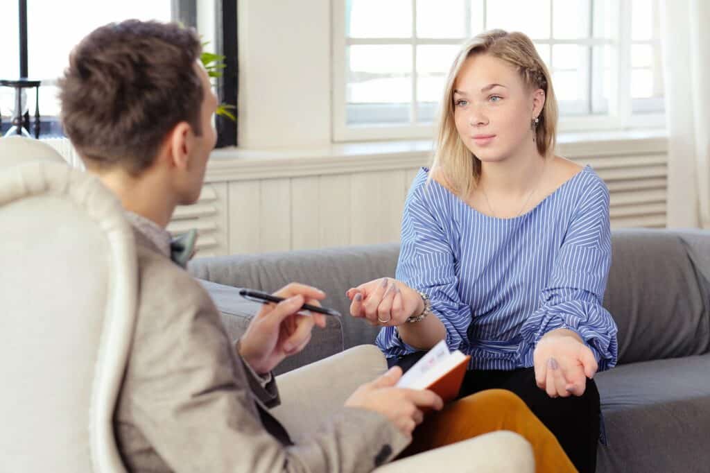 Counselor or Therapist and a female client are in session that looks like EMDR Therapy